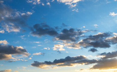 Beautiful orange  sunset clouds on the blue sky. Sky background.