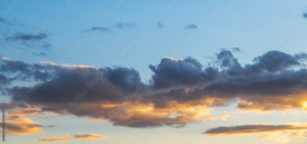 Wall mural beautiful orange sunset clouds on the blue sky. sky background.