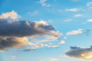 Beautiful orange  sunset clouds on the blue sky. Sky background.