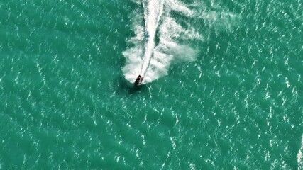 Enjoying a thrilling ride above turquoise waters on a jet ski in a sunny tropical paradise