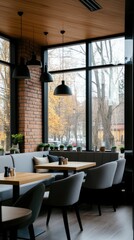 Fototapeta premium Modern cafe interior featuring large windows with autumn views, comfortable seating, and a cozy atmosphere