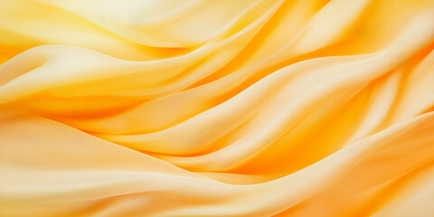 Fototapeta premium Golden yellow silk fabric waves - abstract texture for design and decor