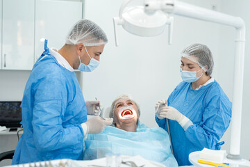 Obraz premium dentist-orthopedic doctor and his assistant examine a young retired woman at clinic