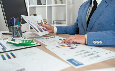  caucasian businessman in suit work with business graph at office