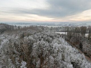 Winter landscape in Germany with frozen frost on trees and fields, drone shot