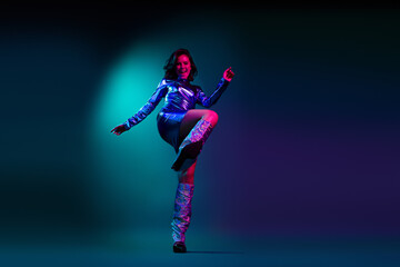 Full body photo of attractive young woman clubbing dressed stylish party retro clothes isolated on dark background
