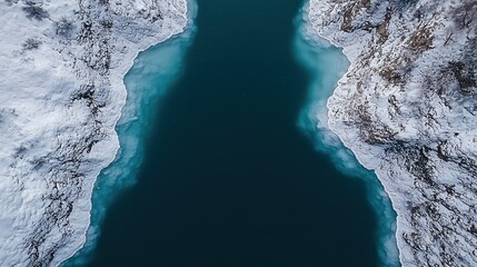 Frozen lake aerial view, icy shores, snowy mountains, winter landscape background.