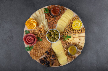 Jarcuterie includes various sausages, cheese, nuts, crackers and fruits. Modern version of festive...