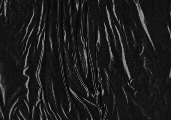 Black transparent plastic wrap texture overlay background. Realistic plastic for poster design and photo overlay effect. Wrinkled paper surface pattern for graphic design sources and element mockup.