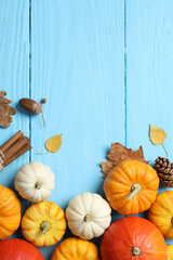 Beautiful autumn composition with pumpkins on a wooden background, top view