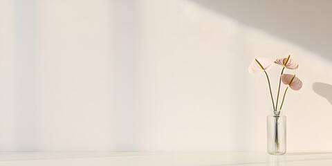 Elegant pink flowers in a glass vase against a minimalist white background. Perfect for home decor or wellness concepts.