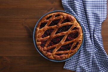 Delicious currant pie on wooden table, flat lay. Space for text