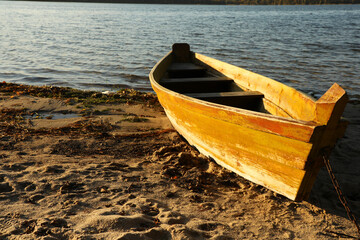 Wooden boat near river on sunny day