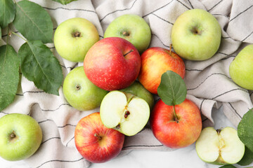 Different ripe apples on towel, flat lay