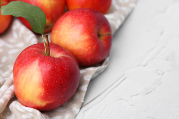 Whole ripe red apples on white table, closeup. Space for text