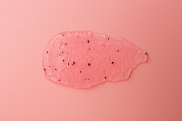 Smear of body scrub on light pink background, top view