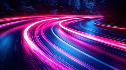Light trails speed on curved road at night, dark forest background.
