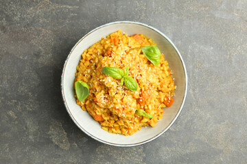 Delicious pumpkin risotto on grey table, top view