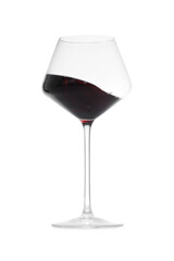 Red wine splashing in glass on white background