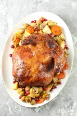 Delicious baked turkey, vegetables and cranberries on gray textured table, top view
