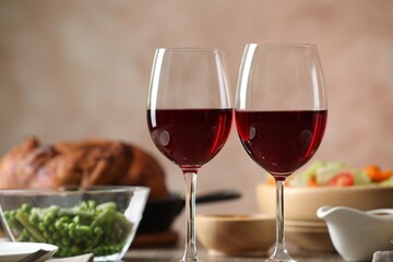Red wine and delicious dinner served on table, closeup