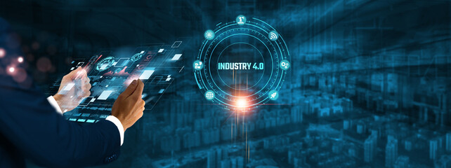 Industry 4.0: Businessman holding virtual interface panel of digital device on global networking, automation, connectivity, smart manufacturing, and digital technology in futuristic.