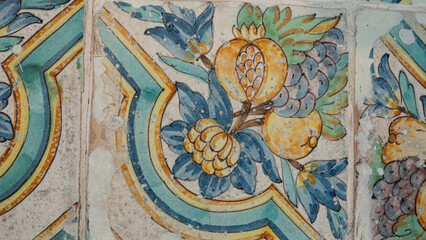 Antique handmade pavement with antique terracotta tiles with fruits and ornaments