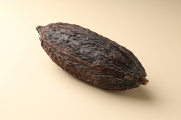 Whole tropical cocoa pod on beige background