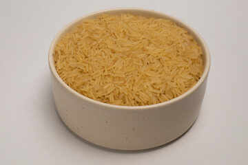 Steamed rice in a deep bowl ready for cooking, dry rice which is filled with vitamins and minerals, vegetarian rice, healthy food, grains of rice in a bowl, a plate of rice on a white background.