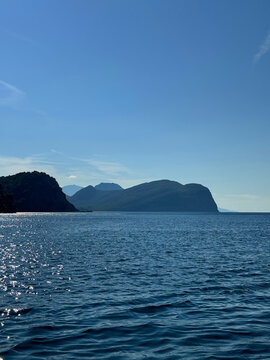 Blue sea, rocks, clear sky horizon.