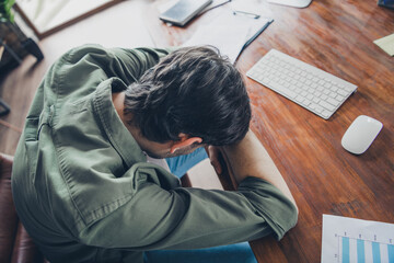 Tired Businessman Resting at Desk in a Modern Office Workspace