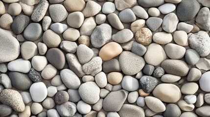 Texture of smooth pebbles on a riverbed, displaying natural shapes, emphasizing the beauty of nature in a serene environment