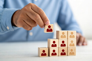 Customer retention concept. Inbound marketing strategy. Attracting potential customers. Hand puts wooden cubes with magnet attracts customer icons on beautiful grey background and copy space. Loyalty