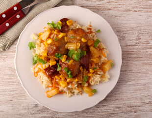 Sweet and sour meatballs with pineapple, corn and pepper