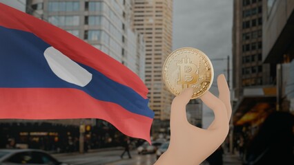 Golden bitcoin held by a hand with a waving Laos flag in the background against a modern urban...