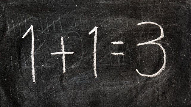 1 + 1 = 3, escrito a mano con tiza en la pizarra