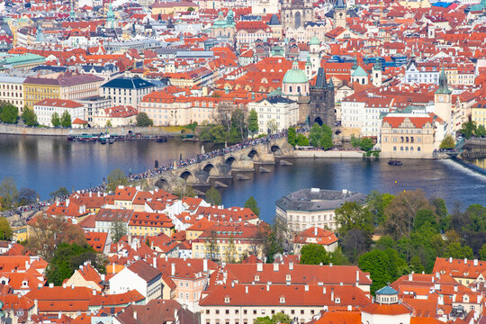 Fototapeta Close photo of Carl's bridge-popular landmark on river Vltava with lot's of tourists in Prague, tower called "Prašná brána" and Old town square in the background.