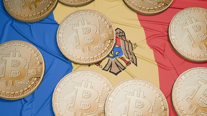 Several bitcoins are laid out on the flag of Moldova