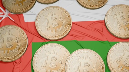 Several bitcoins are laid out on the flag of Oman