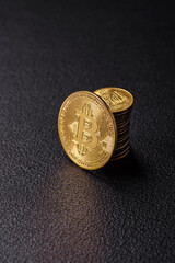 Bitcoin as a metal round coin on a dark background. Cryptocurrency