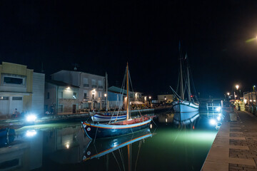 historic boat in the canal in the center of Cesenatico, night photo. High quality photo