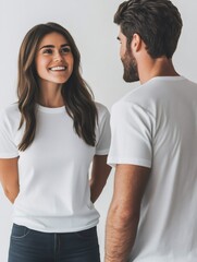 Fototapeta premium Happy couple smiling and interacting, wearing white t shirts