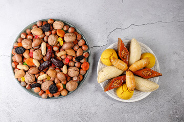 Traditional Azerbaijan holiday Novruz background with green semeni,traditional azerbaijan sweets,shekerbura,qogal,paxlava,mutaki and different nuts and sweets,top view,space for copy