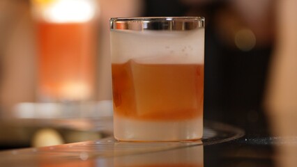 Closeup bartender pouring mixed cocktail whiskey into cool glass textured cooling ice drink making special advertisement creative focusing alcohol refresh showcase at VIP guest background. Vinosity.