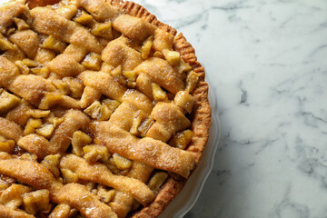 Homemade apple pie on white marble table, top view. Space for text