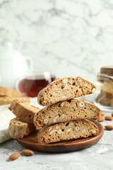 Traditional Italian almond biscuits (Cantucci) on grey textured table, closeup