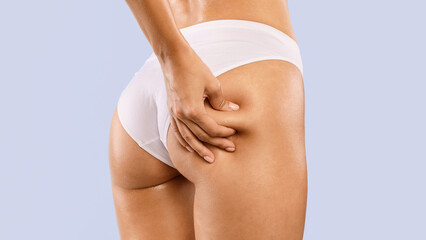Skin Elasticity Check Concept. Closeup cropped view of unrecognizable young woman pinching her...