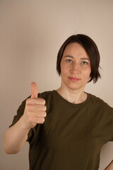 Portrait of Asian woman looking at camera and showing like.