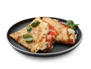 Delicious crepes with salmon, cream cheese and basil isolated on white