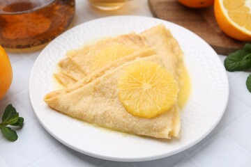 Delicious Crepes Suzette on white table, closeup
